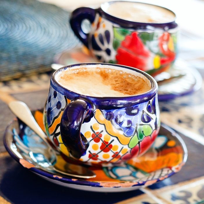 Cappuccino in traditional colorful mexican pottery cups;
