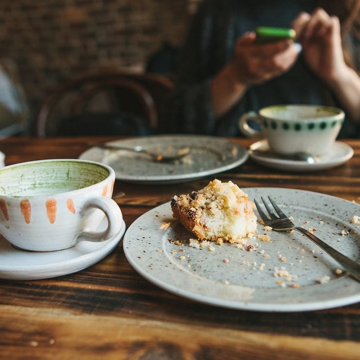 A dirty plate and an empty cup of coffee