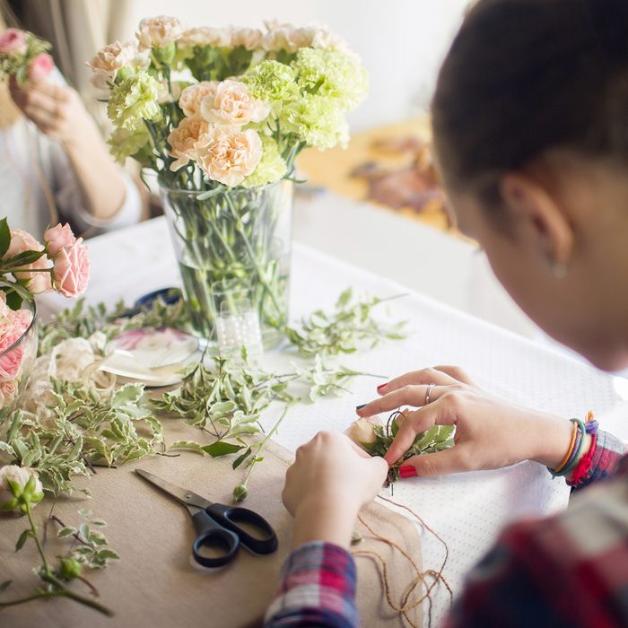 girl mastering a boutonniere on flower masterclass