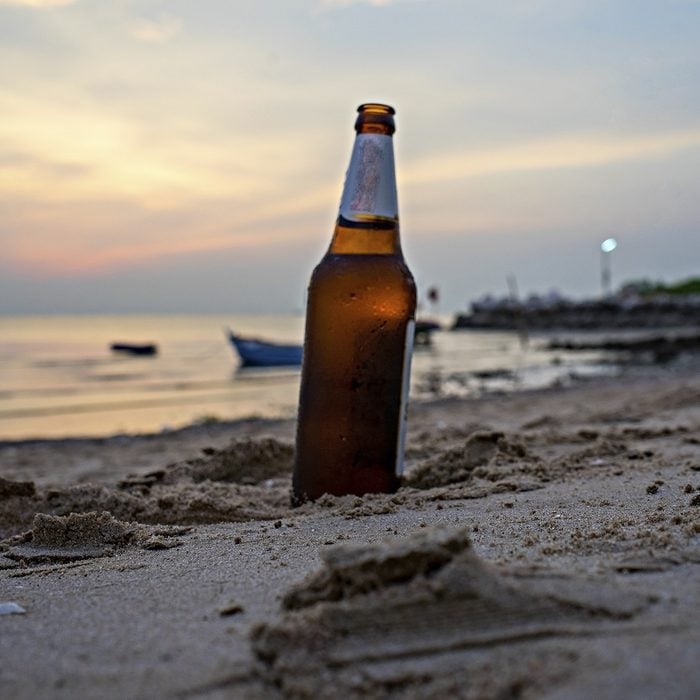 glass bottle Beer at the beach sunset 