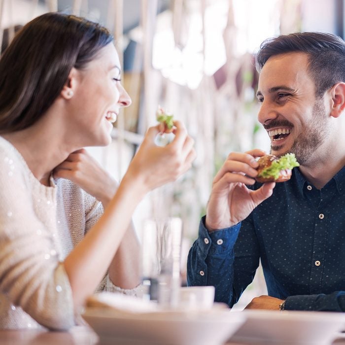 Happy loving couple enjoying breakfast in a cafe.