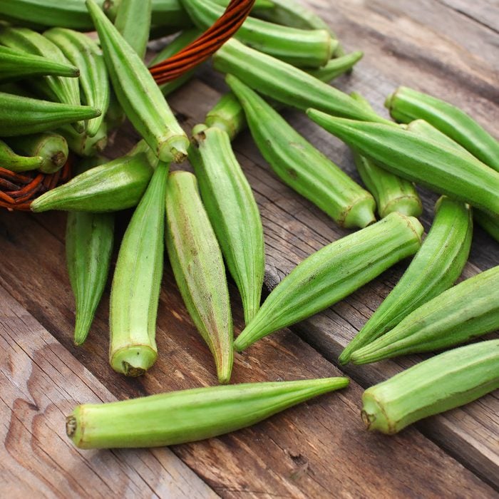 Lady Fingers or Okra over wooden table background