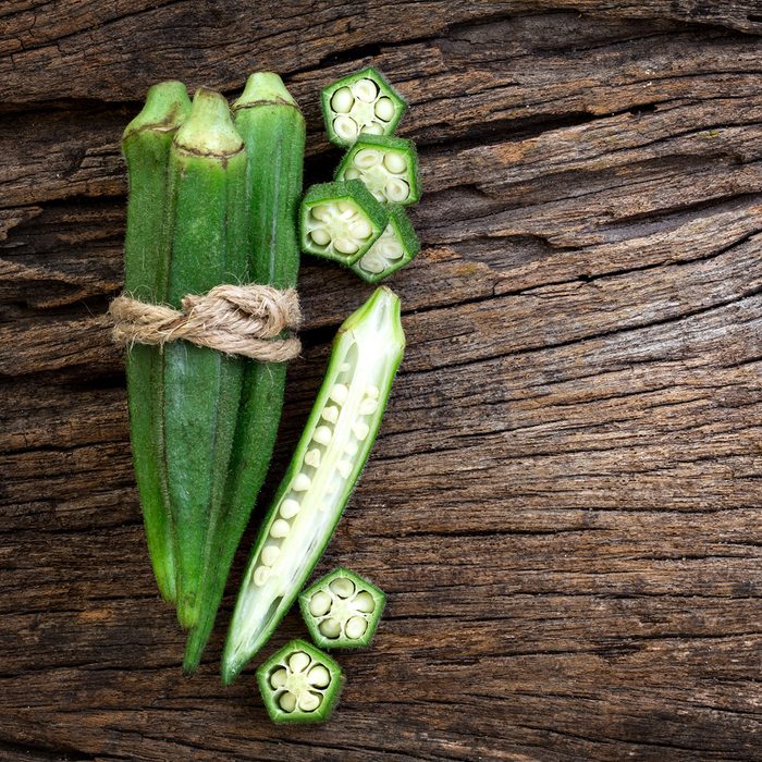 Close up the fresh okra on wooden plate