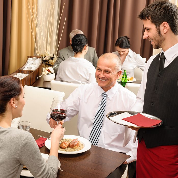 Business lunch executive people toast with red wine young waiter serve; Shutterstock ID 100260941; Job (TFH, TOH, RD, BNB, CWM, CM): Taste of Home