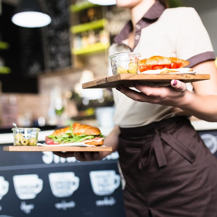 Female waitress is carrying two plates with sandwiches.; Shutterstock ID 1154258752; Job (TFH, TOH, RD, BNB, CWM, CM): Taste of Home