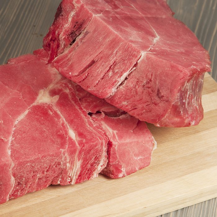 Two pieces of frozen beef on a board; Shutterstock ID 177201707; Job (TFH, TOH, RD, BNB, CWM, CM): TOH