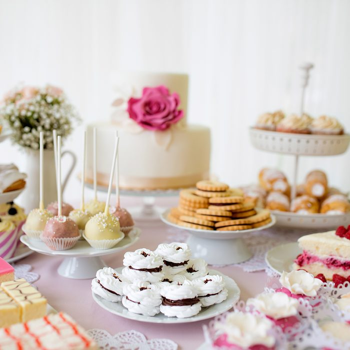 Table with loads of cakes, cupcakes, cookies and cakepops.