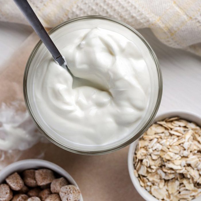 Yogurt beside oats in separate bowls