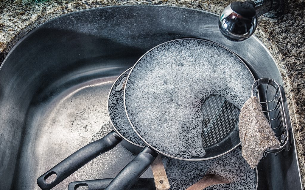 Dirty dishes in the sink waiting to be washed up