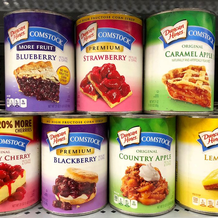 Grocery Store shelf with cans of Duncan Hines brand fruit pie fillings.
