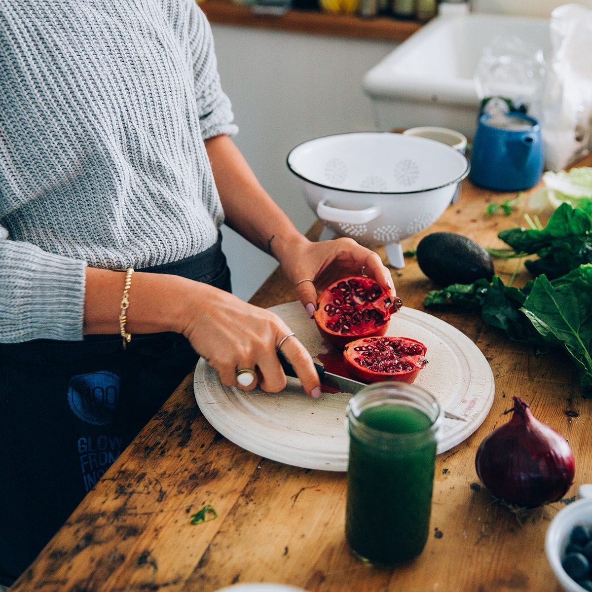 Hands Of Woman Cutting Pomegranate