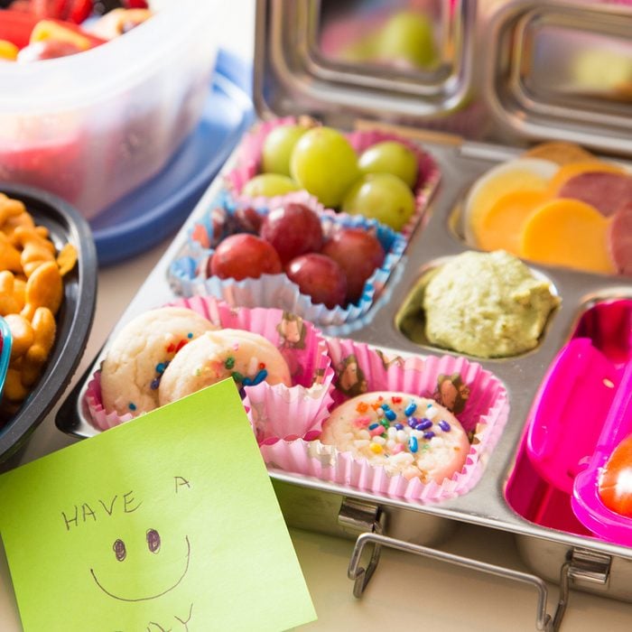 Mom packs a happy note of encouragement with a colorful Bento box lunch packed with healthy fruits, veggies and snacks
