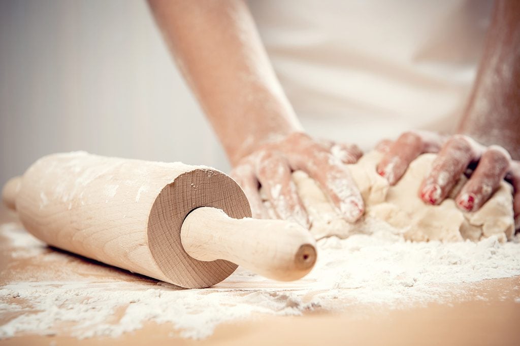 Woman kneading dough, close-up photo; Shutterstock ID 139422398
