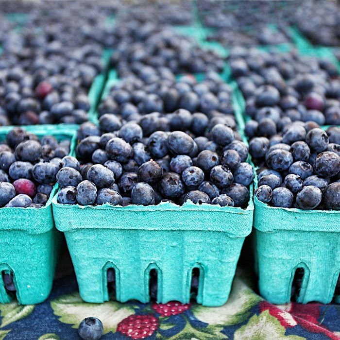 Blueberries in crates at farmers market farm fresh organic fruit in the summer for sale with depth of field; Shutterstock ID 393591292