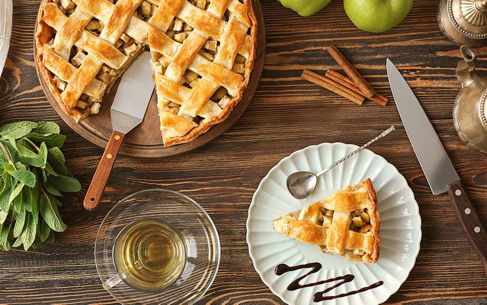 Composition with tasty homemade apple pie on wooden background