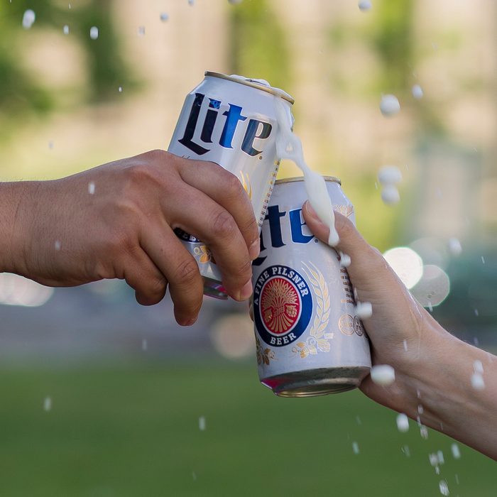 Toasting cans of Miller Lite