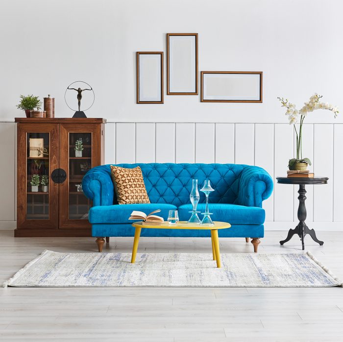 White room with bright blue couch