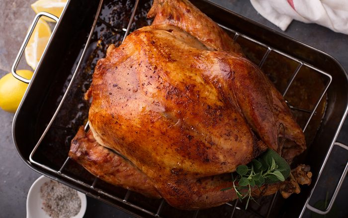 Cooked turkey for Thanksgiving or Christmas in a roasting pan ready for carving