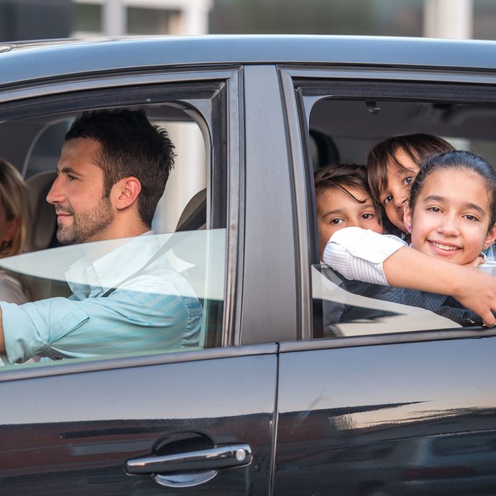 Outside view of a beautiful family driving in automobile
