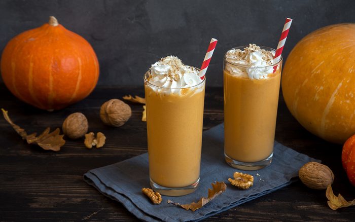 Pumpkin Smoothie. Fresh Pumpkin and Apple Smoothie or Milkshake with Walnuts and Autumn Spices. Seasonal Autumn Drink.