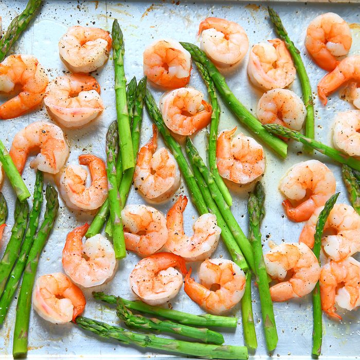 Sheet pan dinner of shrimp and asparagus with olive oil and black pepper