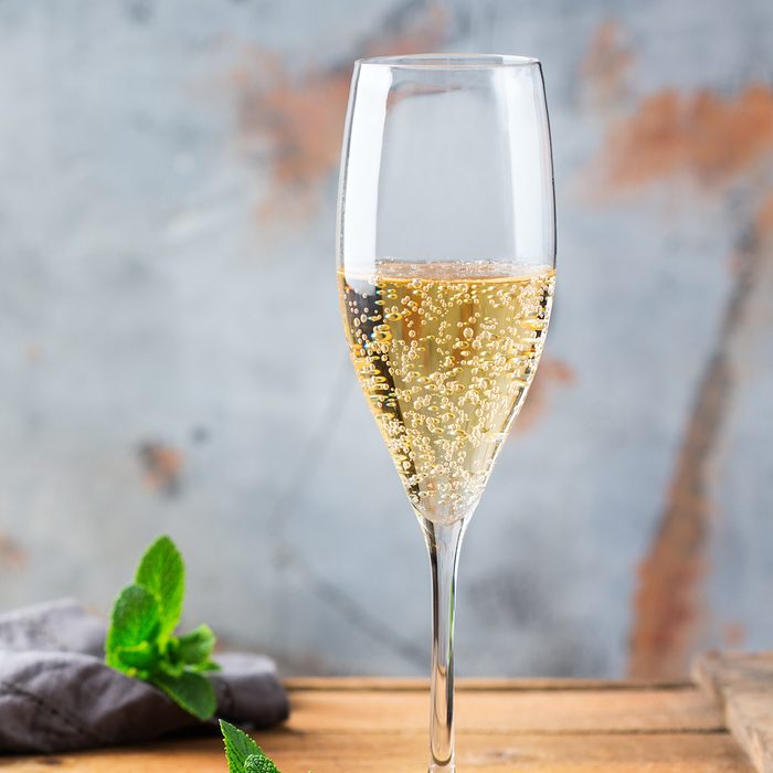 Food and drink, holidays party concept. Cold fresh alcohol beverage champagne sparkling white wine with bubbles in a flute glass on a wooden table. Copy space background; Shutterstock ID 1086809027; Job (TFH, TOH, RD, BNB, CWM, CM): TOH
