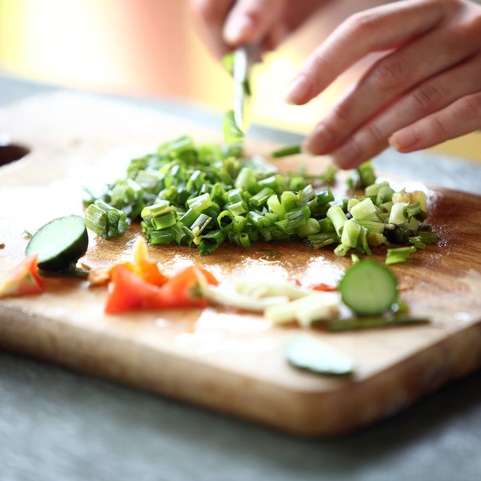 Closeup of Human hands cooking vegetables salad in kitchen; Shutterstock ID 116301946