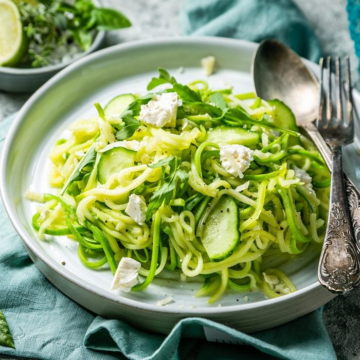 Zucchini noodles with cucumber, feta cheese and arugula, rustic background; Shutterstock ID 1220659900; Job (TFH, TOH, RD, BNB, CWM, CM): Taste of Home