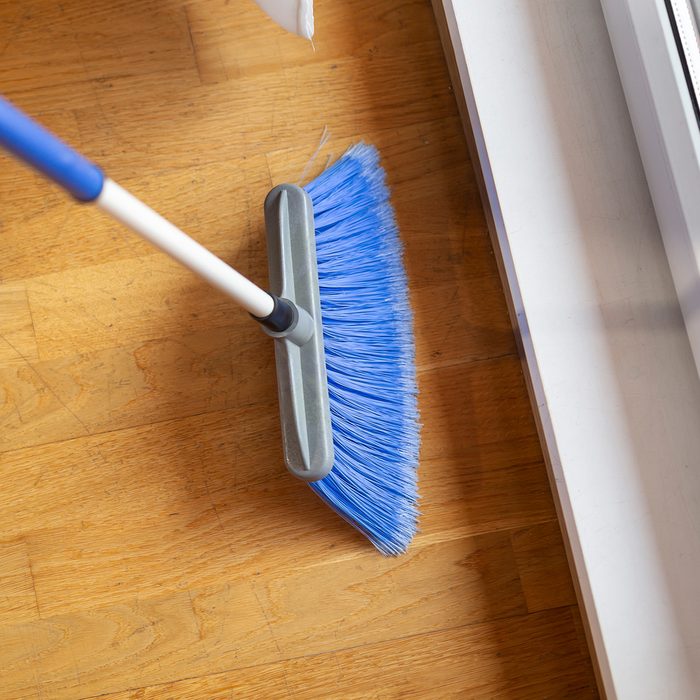 High angle view of female hands holding a broom and sweeping floor; Shutterstock ID 1223043931; Job (TFH, TOH, RD, BNB, CWM, CM): TOH