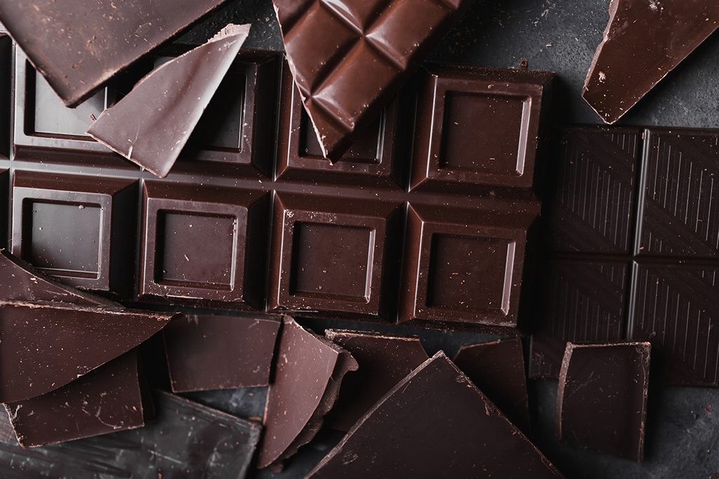 Broken slices of chocolate close up; Shutterstock ID 564089023