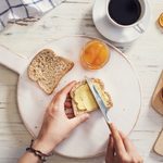 Woman hand spreading butter on sliced bread; Shutterstock ID 645603709; Job (TFH, TOH, RD, BNB, CWM, CM): Taste of Home
