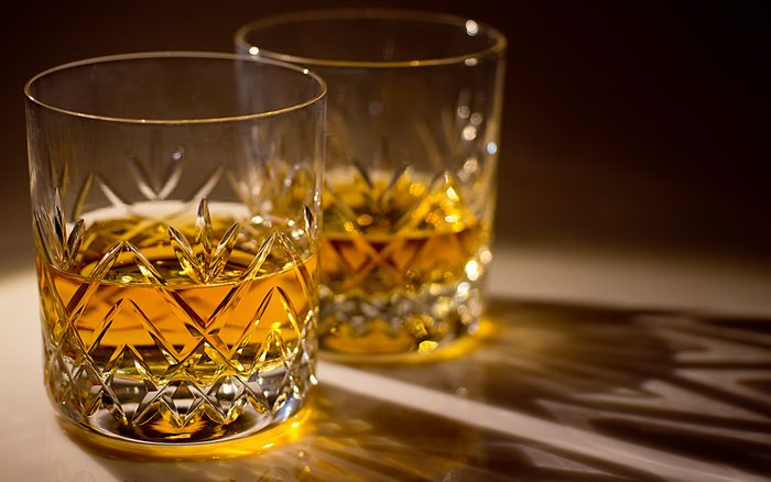 two cut crystal whisky glasses with whisky