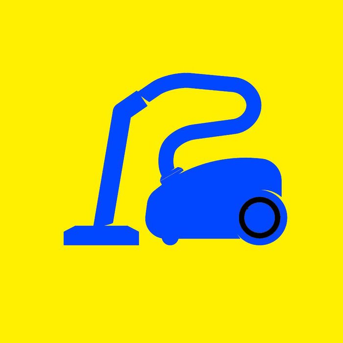 Blue vacuum against a yellow background