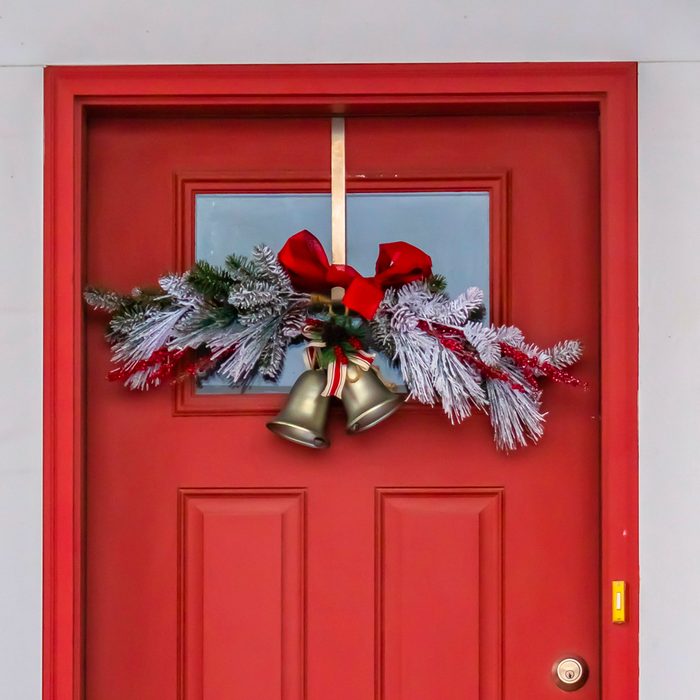 Red Square Front Door With Glass Panel And Holiday Decorations with Holiday Branches, Ribbons and Gold Bells