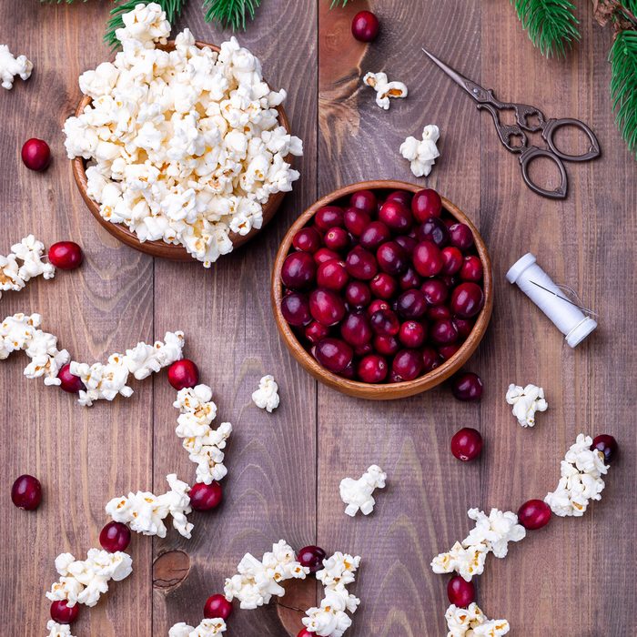Handcrafted Christmas Popcorn Garland With Red Cranberries and white popped popcorn threaded onto a string with a needle and thread to decorate your Christmas Tree in a Zero Waste Eco friendly way