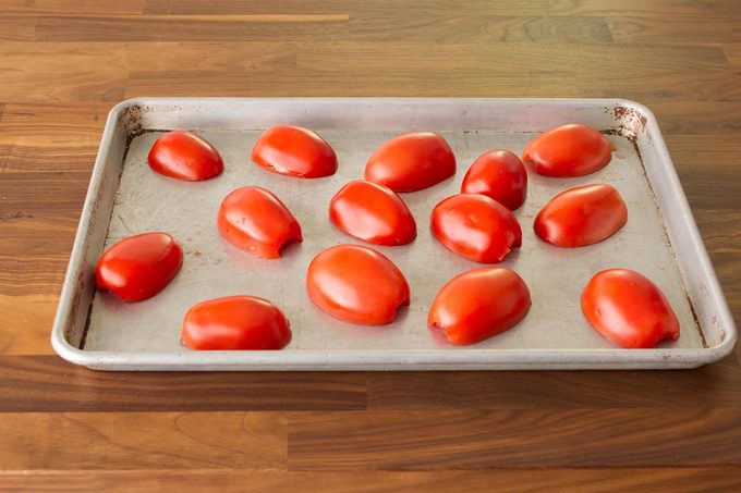 halved tomatoes on sheet pan