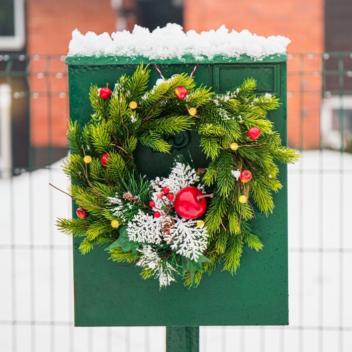 Domestic Mail Box Decorated With Spruce Tree Christmas Wreath Outdoors In Snowy Winter Day