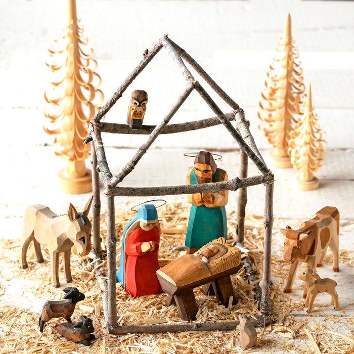 Natural Wood Nativity Scene made of sticks, straw and natural wood on a bright, white background