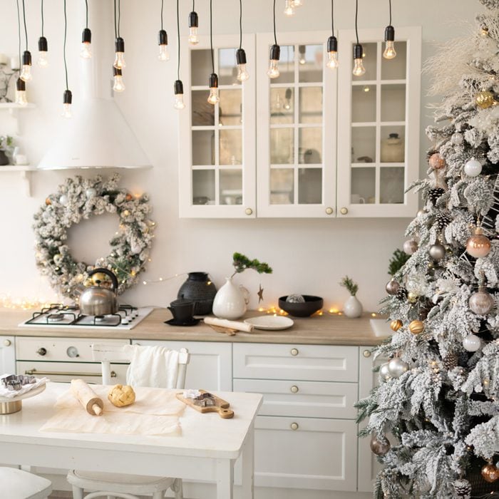Interior White Kitchen With Christmas Decor And Decorated Fir Tree