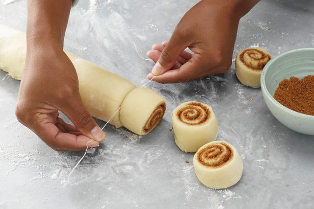 How to make Taste of Home's contest winning Best Cinnamon Rolls recipe; step 3 of 5; roll up dough jellyroll style and cut into pieces using dental floss