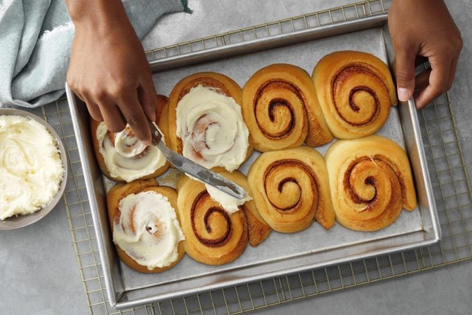 How to make Taste of Home's contest winning Best Cinnamon Rolls recipe; step 5 of 5; spread baked rolls with cream cheese frosting