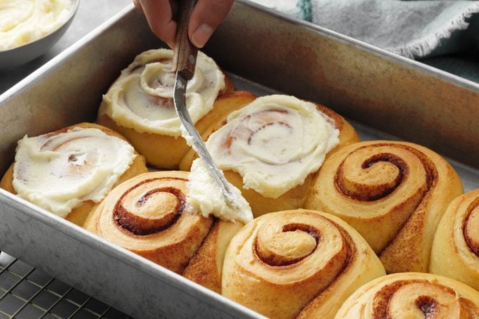 How to make Taste of Home's contest winning Best Cinnamon Rolls recipe; step 5 of 5; spread baked rolls with cream cheese frosting