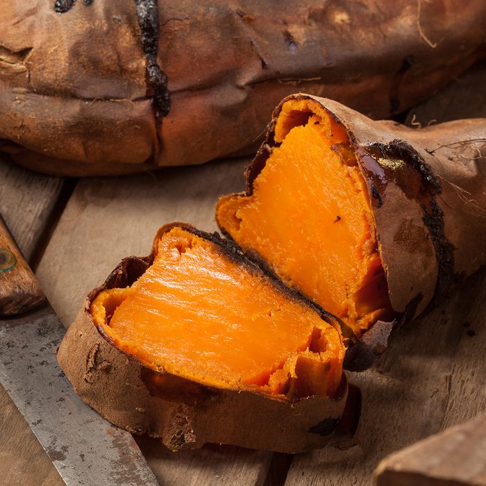 Oven baked sweet potatoes on vintage wood.