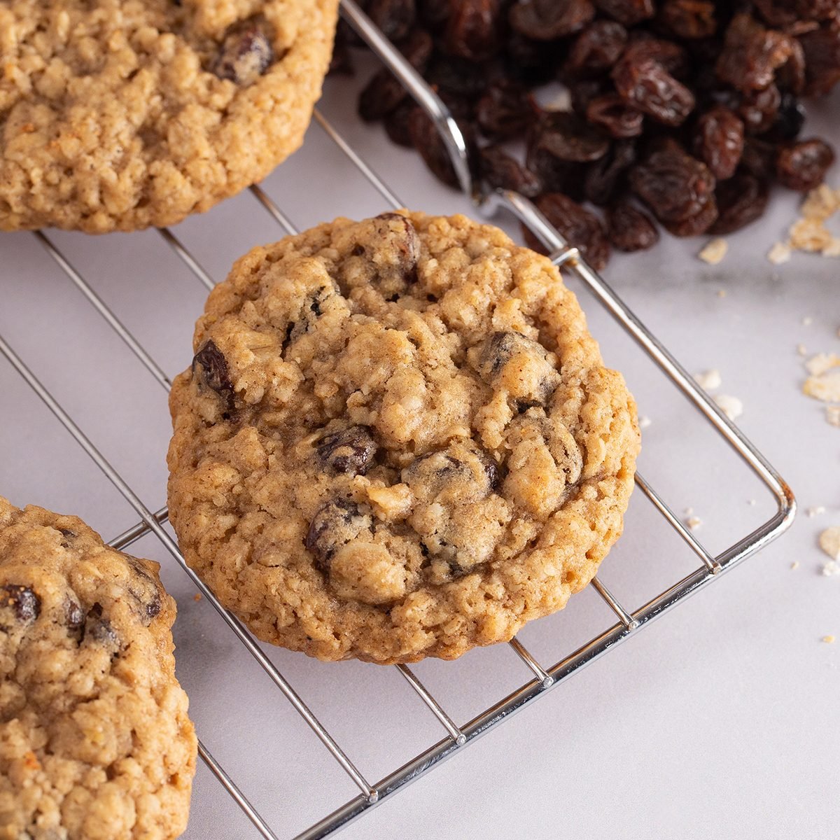 Cinnamon Raisin Oatmeal Cookies with Raw Ingredients on a Marble Counter