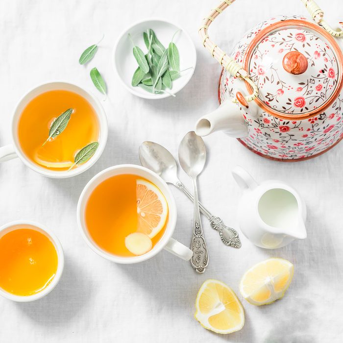 Cough tea. Green tea with lemon, ginger, sage on a light background