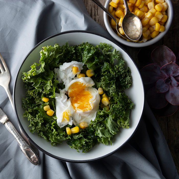 Poached eggs with Kale lettuce, salad. Healthy breakfast or dinner.