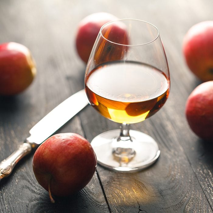 whiskey and apples on dark wooden table; Shutterstock ID 736289938; Job (TFH, TOH, RD, BNB, CWM, CM): TOH