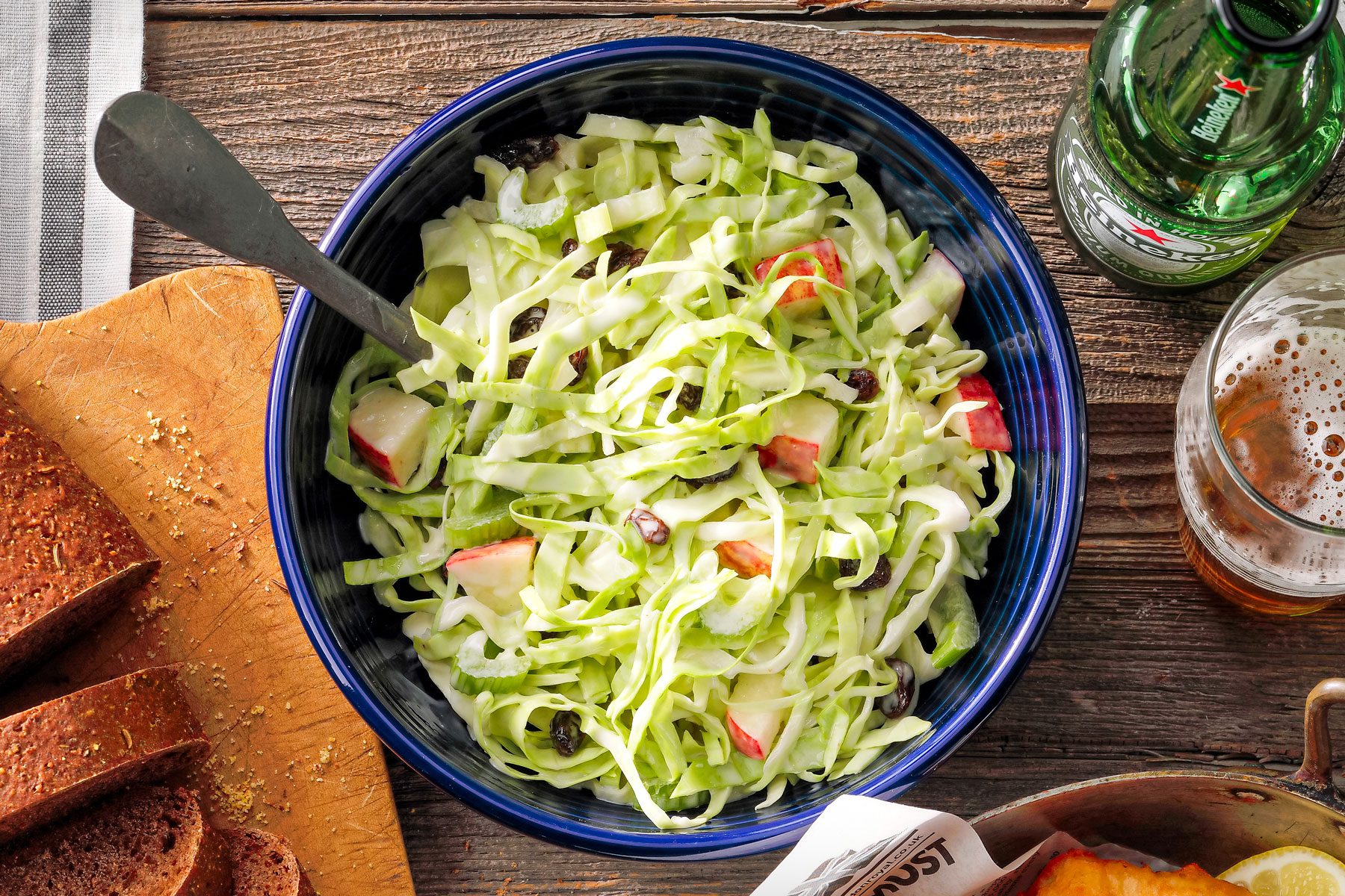 Apple Slaw in a Ceramic Blue Bowl on Wooden Surface