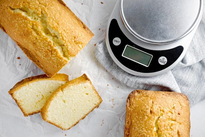 Classic Pound Cake sliced with a scale to the side