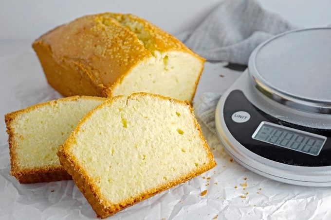 Classic Pound Cake sliced with a scale to the side